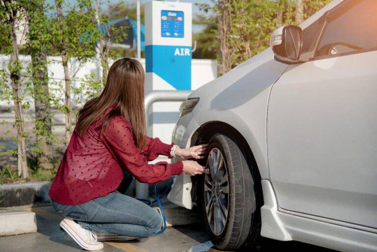 Woman inflating tyres at tyre pressure machine